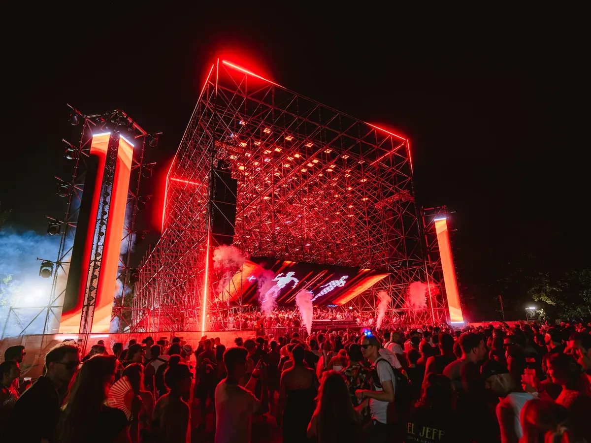 Main screen content under the lit volumetric matrix at night, Sunrise Stage, Isle of Summer Vienna 2026